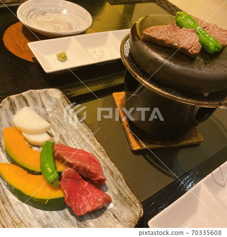 Luxury Japanese beef steak on lava stone grilled plate Luxury Japanese beef steak on lava stone grilled plate 70335608
