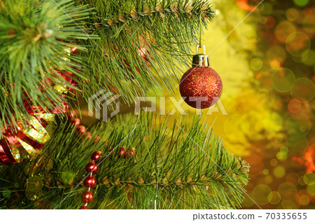 Christmas tree with red ball and tinsel Christmas tree with red ball and tinsel 70335655