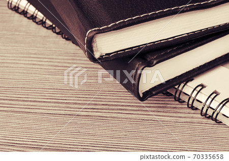Stack of notebooks on a table Stack of notebooks on a table 70335658