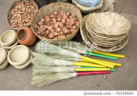 broom,wicker plate and clay cups in bazaar,India 70336985