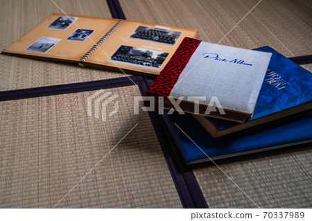 View an old album by the window 70337989