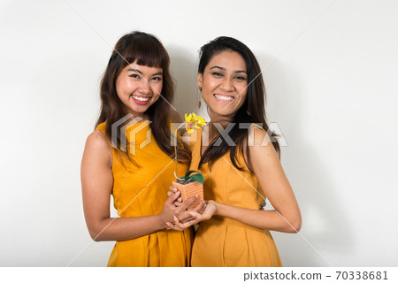 Portrait of two happy young Asian women together Portrait of two happy young Asian women together 70338681