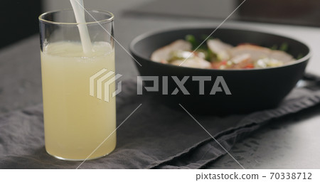 Pour lemonade with salad bowl on background on concrete countertop 70338712