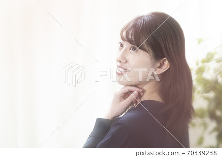 A woman looking at the camera wearing a tank top 70339238