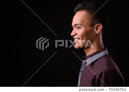 Closeup profile view of young handsome Indian businessman Closeup profile view of young handsome Indian businessman 70340763