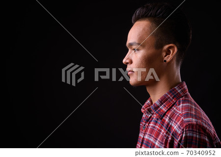 Closeup profile view of young handsome Indian hipster man 70340952