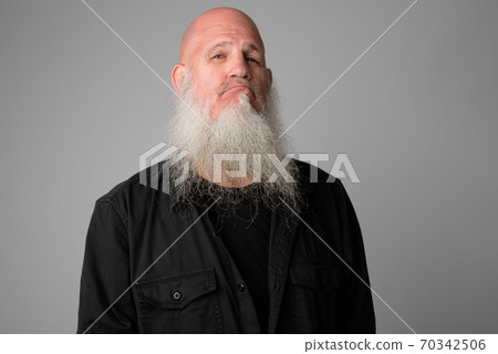 Face of mature bald man with long beard making smug expression Face of mature bald man with long beard making smug expression 70342506