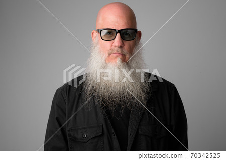 Face of mature handsome bald man with long beard wearing sunglasses 70342525