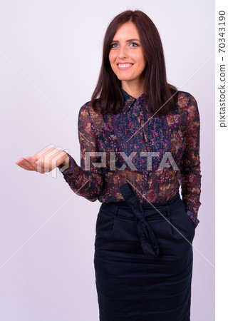 Portrait of happy young beautiful businesswoman showing something 70343190