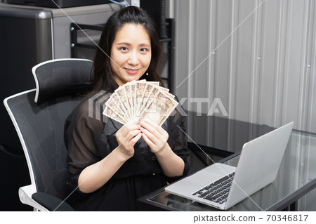 Woman holding money Woman holding money 70346817