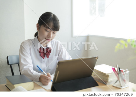 High school girl taking remote lessons at home 70347269