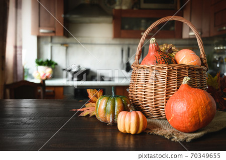 Blurred kitchen with pumpkins on table top Blurred kitchen with pumpkins on table top 70349655