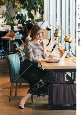 A woman working in a cafe A woman working in a cafe 70349670