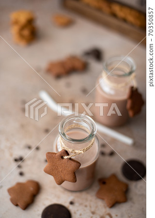 chocolate milkshake in glass bottle with gingerbread crumbly cookies 70350857