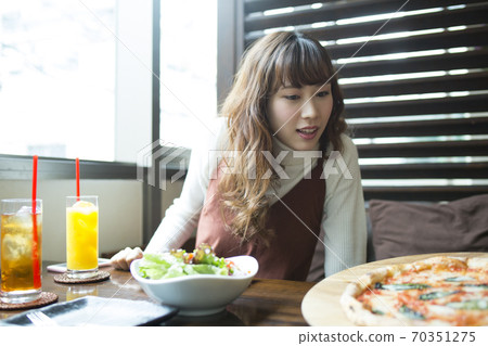 A woman dining at a cafe A woman dining at a cafe 70351275