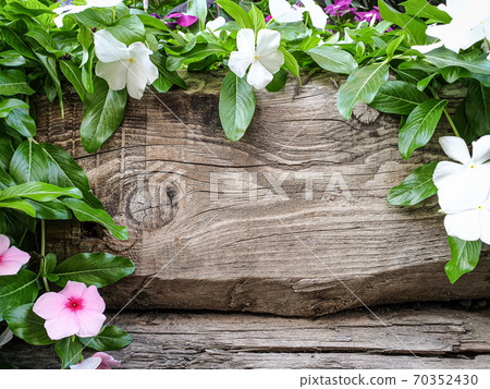 Rustic wooden surface with flowers 70352430