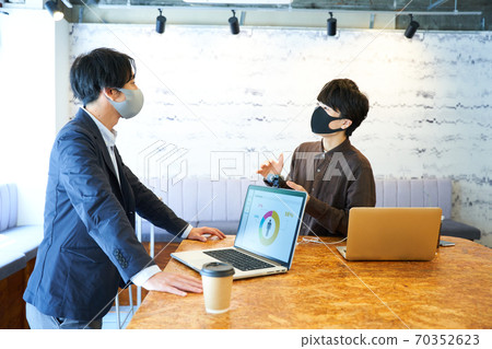 Two men working in a cafe 70352623