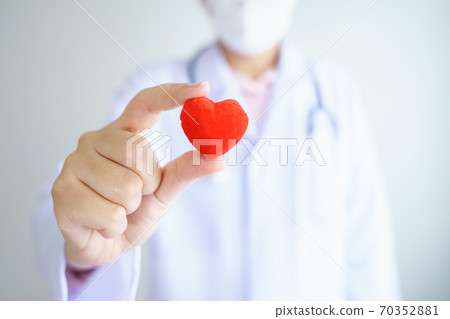 Heart check Doctor holding Red heart on hands at hospital office.Healthcare And Medical concept. Heart check Doctor holding Red heart on hands at hospital office.Healthcare And Medical concept. 70352881