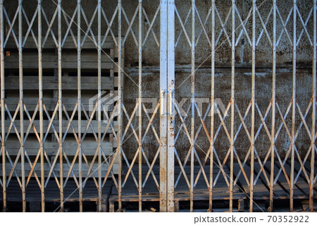 asian rustiness chinese traditional gate or folding doors in the shop with the vintage style - architectural structure in Yau Ma Tei Wholesale Fruit Market in china hong kong asian rustiness chinese traditional gate or folding doors in the shop with the vintage style - architectural structure in Yau Ma Tei Wholesale Fruit Market in china hong kong 70352922