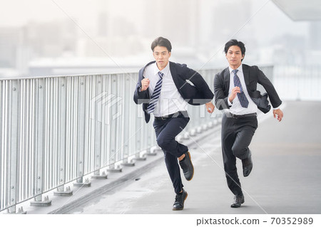 Two businessmen running at full power Two businessmen running at full power 70352989