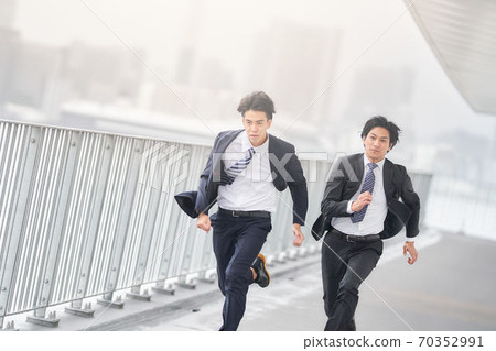 Two businessmen running at full power Two businessmen running at full power 70352991