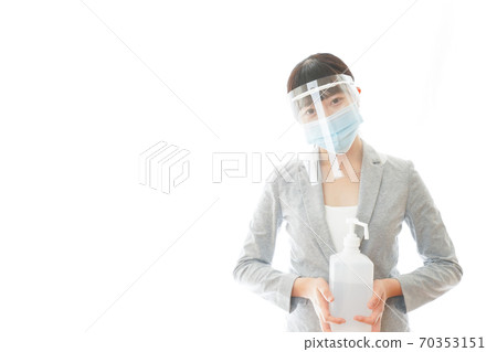 Business woman with face shield with alcohol disinfectant Business woman with face shield with alcohol disinfectant 70353151