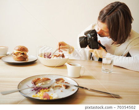 Woman is photo shooting of restaurant food 70354502