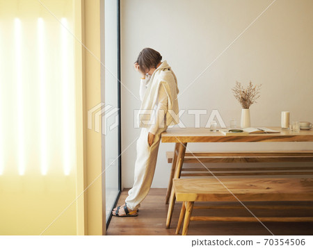 Sad woman near the window. kinfolk style 70354506