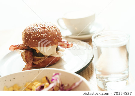 hamburger with bacon, cheese and sesame with coffee 70354527