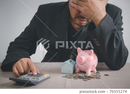 Businessman is stressed out of losing their jobs and insufficient savings to pay for a mortgage. Businessman is stressed out of losing their jobs and insufficient savings to pay for a mortgage. 70355274