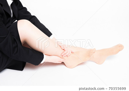 A woman with a foot massage A woman with a foot massage 70355699
