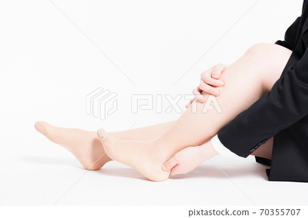 A woman with a foot massage A woman with a foot massage 70355707