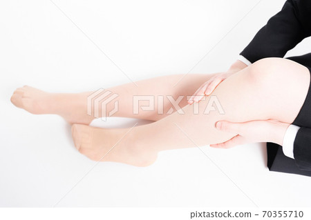 A woman with a foot massage A woman with a foot massage 70355710