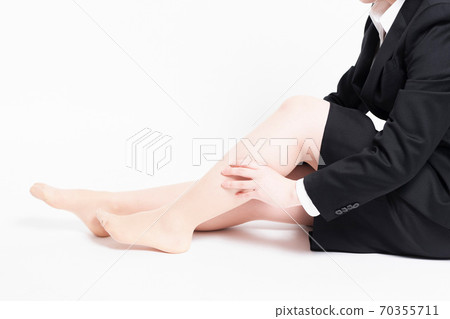 A woman with a foot massage A woman with a foot massage 70355711