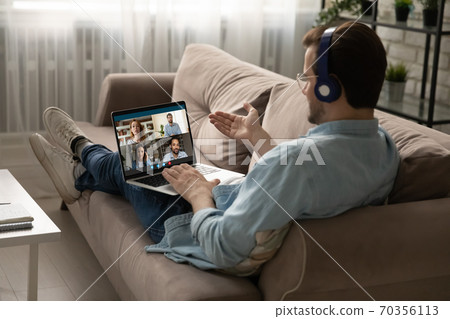 Man in headphones have team online meeting on laptop 70356113