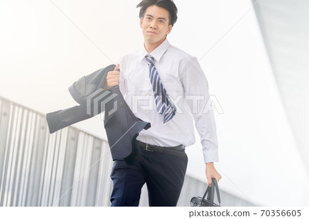 A man in a suit running with a bag A man in a suit running with a bag 70356605