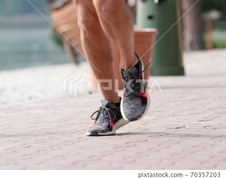 Naked male legs in sports running sneakers run Naked male legs in sports running sneakers run 70357203