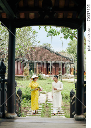 Asian couple walking to temple 70357505