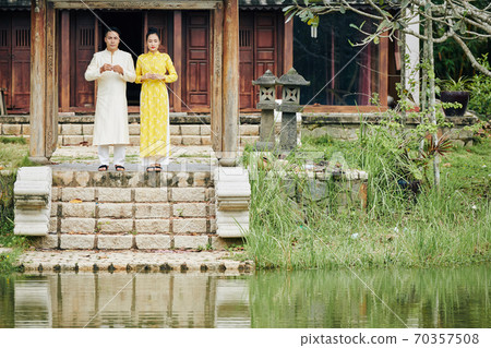 Couple standing in front of temple Couple standing in front of temple 70357508
