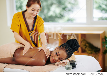 Woman getting body massage Woman getting body massage 70357580