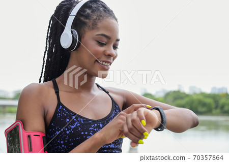Sportswoman checking fitness tracker Sportswoman checking fitness tracker 70357864