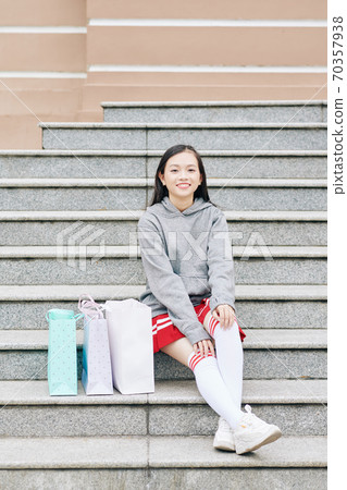 Teenage girl sitting on steps 70357938