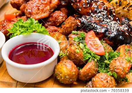 Barbecue chicken with vegetables on wooden table 70358339