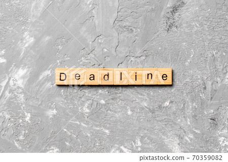 DEADLINE word written on wood block. DEADLINE text on cement table for your desing, concept DEADLINE word written on wood block. DEADLINE text on cement table for your desing, concept 70359082