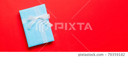 Top view Christmas present box with white bow on red background with copy space Top view Christmas present box with white bow on red background with copy space 70359182