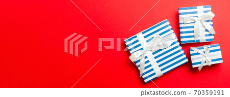 Top view Christmas present box with White bow on red background Top view Christmas present box with White bow on red background 70359191