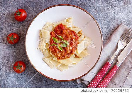 Short pasta dish with tomato sauce and basil Short pasta dish with tomato sauce and basil 70359783