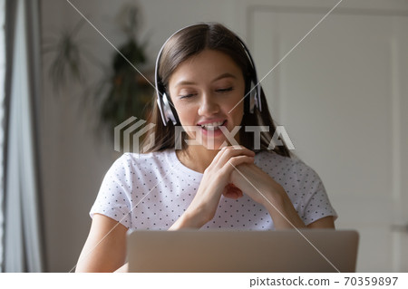 Happy young pretty woman enjoying pleasant conversation at home office. 70359897