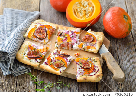 Tarte Flambee from Alsace with goats cream cheese, onions, pumkin and fig slices 70360119