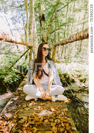 woman relax in autumn forest 70360239